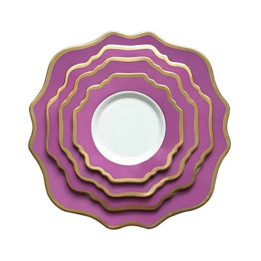Set of purple plates with gold rims on a white background
