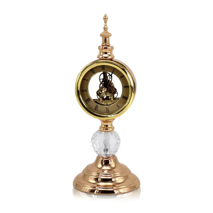 Decorative clock with gold and crystal design on a white background